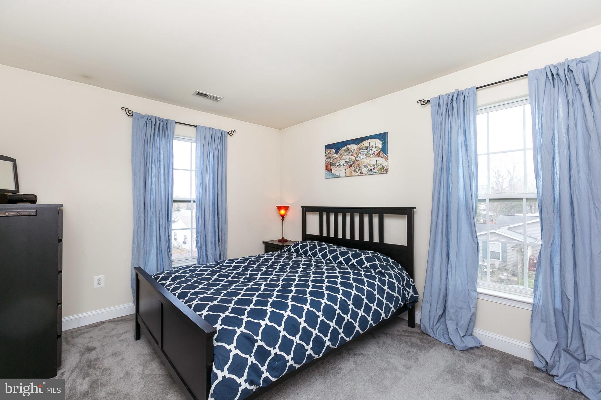 1305 3rd Road Baltimore, MD 21220 - Photo 14 of 27 a bedroom with a large bed and a window