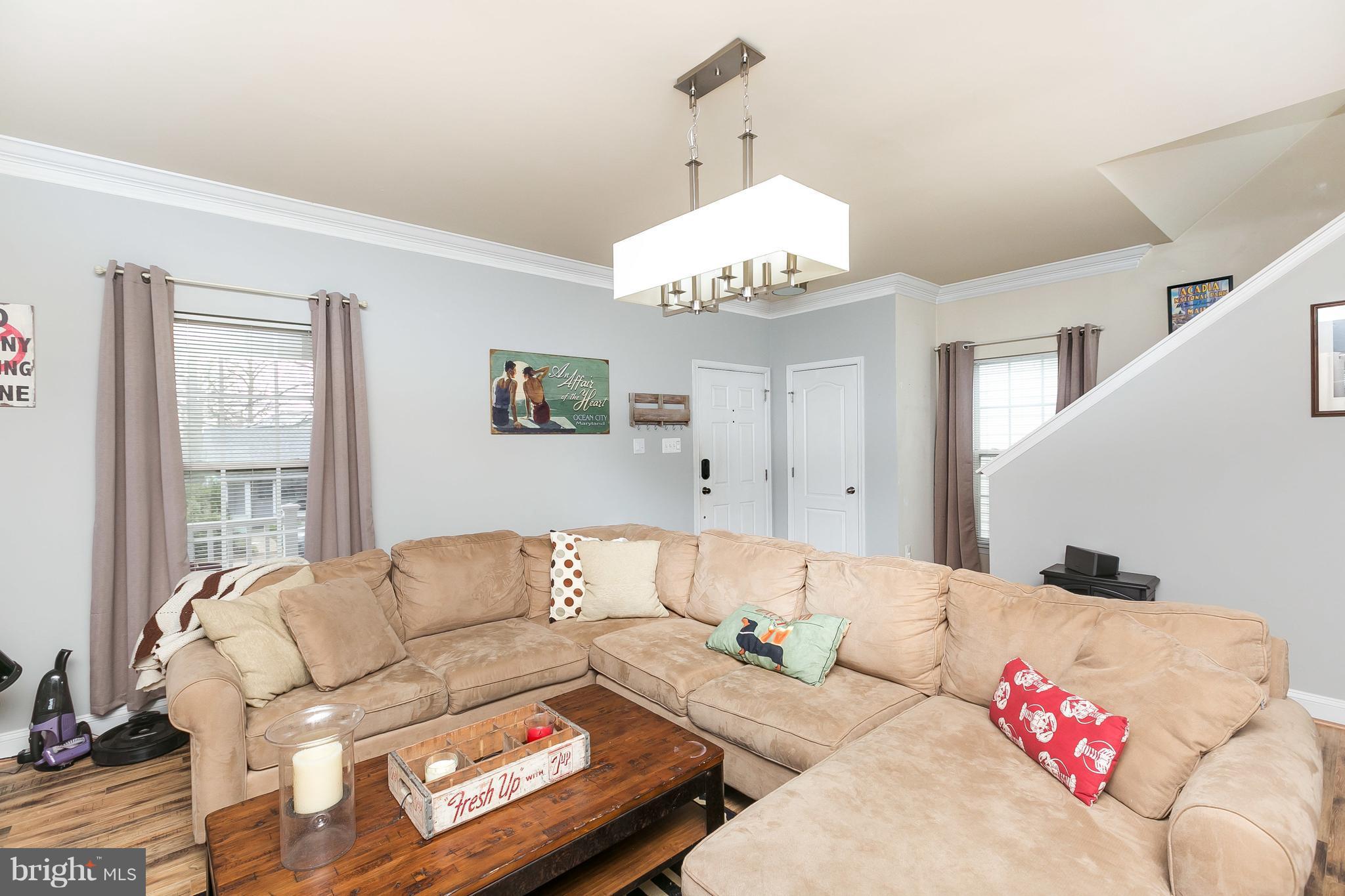 1305 3rd Road Baltimore, MD 21220 - Photo 9 of 27 a living room with furniture and a chandelier