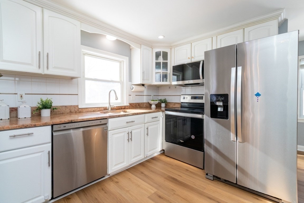 236 Fellsway West Medford, MA 02155 - Photo 12 of 39 a kitchen with stainless steel appliances a refrigerator sink and cabinets