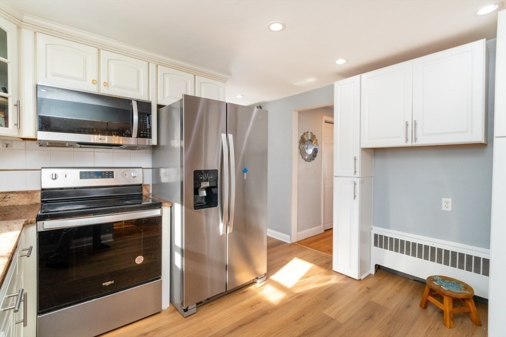 236 Fellsway West Medford, MA 02155 - Photo 13 of 39 a kitchen with granite countertop a refrigerator and a stove top oven