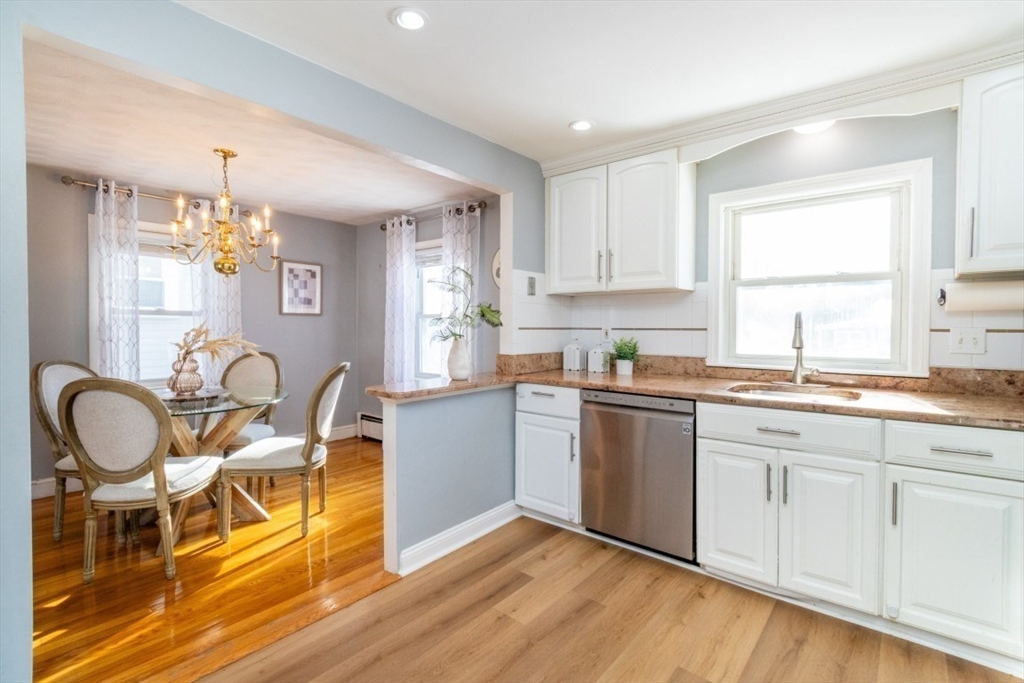 236 Fellsway West Medford, MA 02155 - Photo 15 of 39 a kitchen with granite countertop cabinets a dining table and chairs
