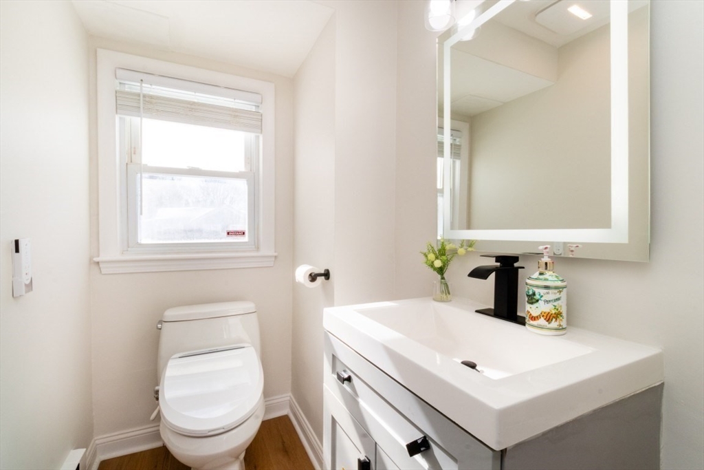 236 Fellsway West Medford, MA 02155 - Photo 16 of 39 a bathroom with a sink a toilet and a mirror