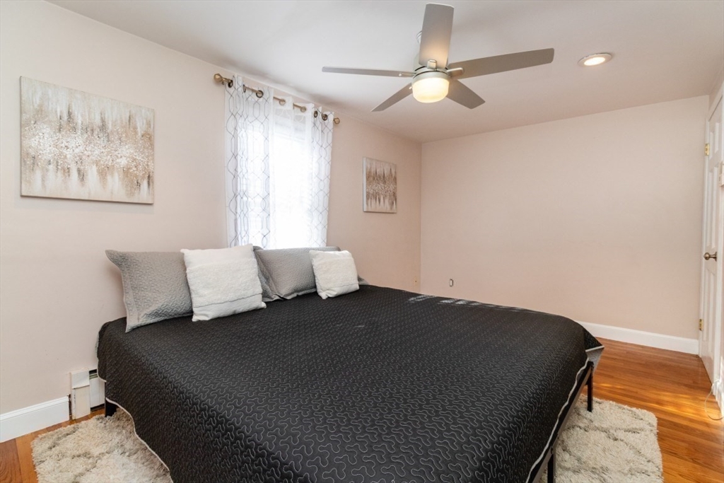 236 Fellsway West Medford, MA 02155 - Photo 20 of 39 a bedroom with a bed and a chandelier