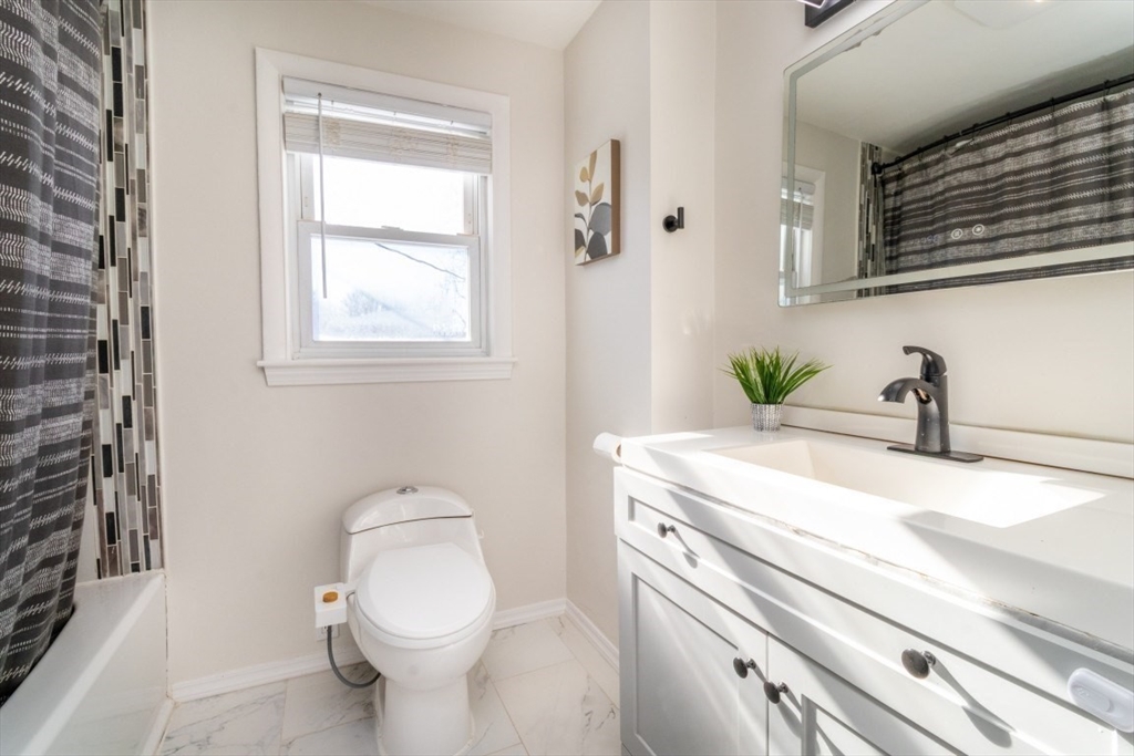 236 Fellsway West Medford, MA 02155 - Photo 26 of 39 a bathroom with a sink a toilet and a mirror
