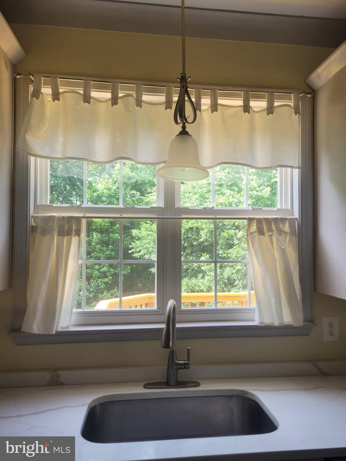 1202 Strausberg Street Accokeek, MD 20607 - Photo 18 of 43 Bright kitchen window with soft curtains.