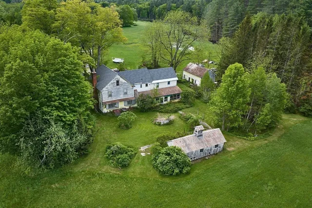 an aerial view of a house with a yard