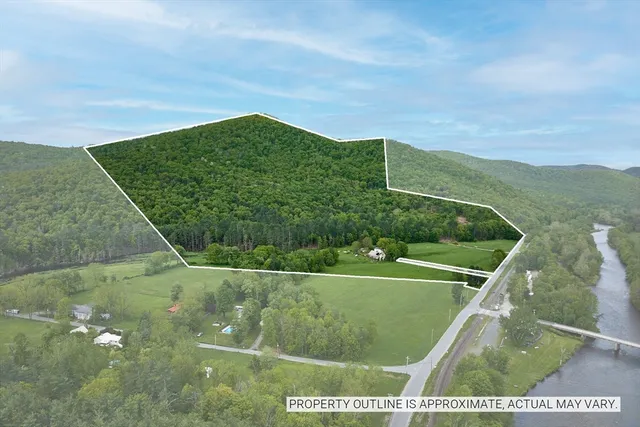 a view of a field with a view of mountains