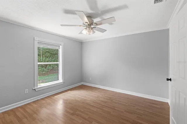 wooden floor in an empty room with a window