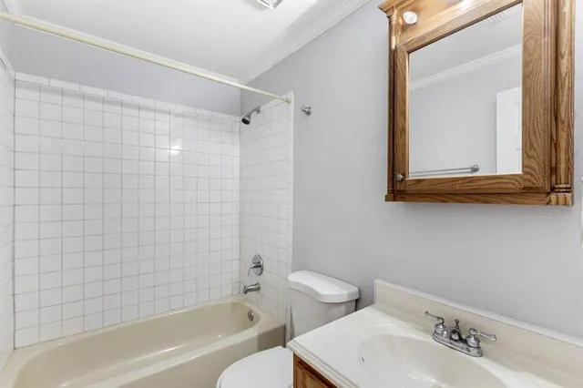 a bathroom with a bathtub shower sink and a toilet