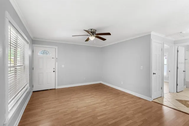 wooden floor in an empty room with a window
