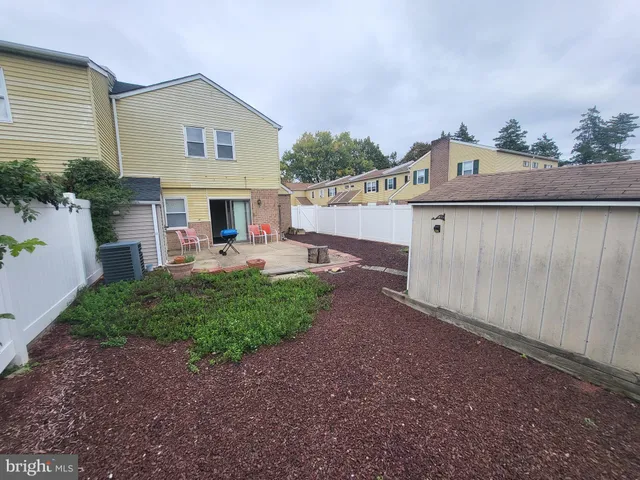 a view of a house with a yard and furniture