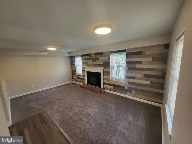 a view of an empty room with a fireplace