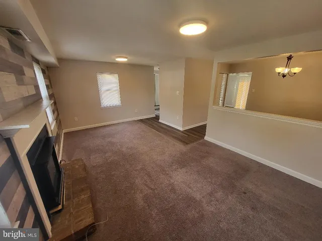 a view of an empty room with a fireplace
