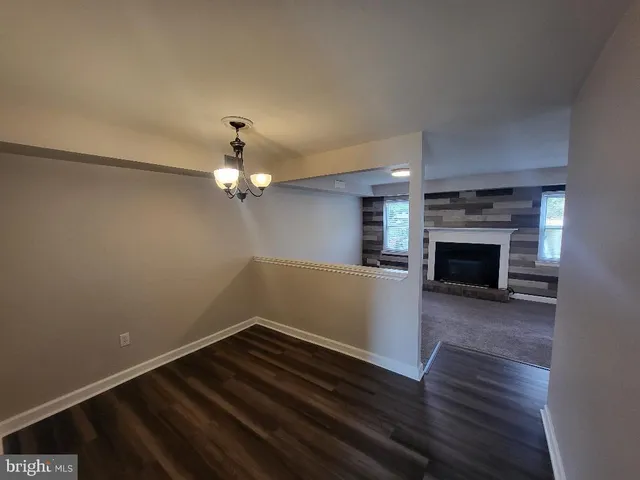 wooden floor in an empty room with a fireplace