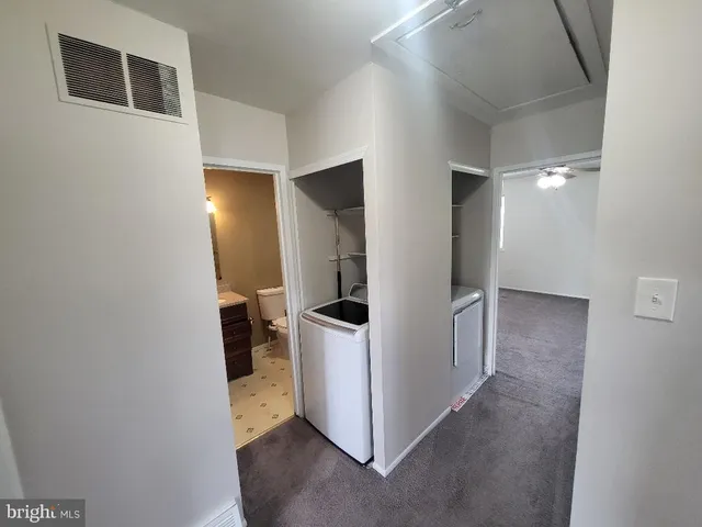 a view of a storage & utility room with a sink