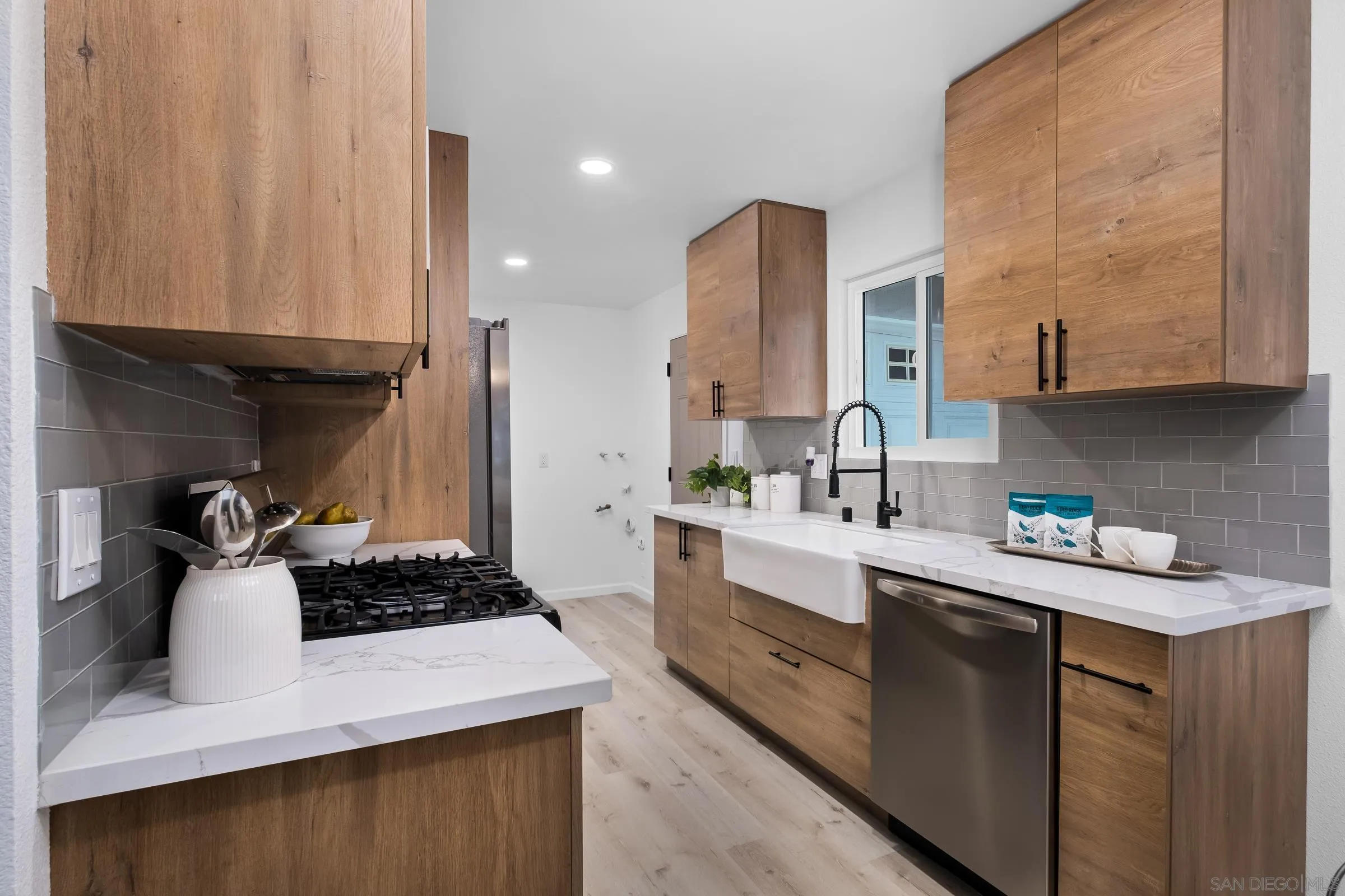 3757 Gail Drive Oceanside, CA 92056 - Photo 8 of 27 a kitchen with a sink a stove and cabinets