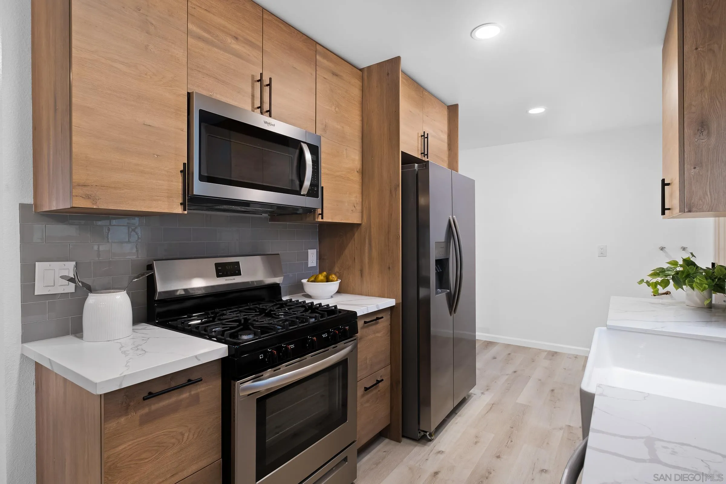 3757 Gail Drive Oceanside, CA 92056 - Photo 9 of 27 a kitchen with stainless steel appliances a stove microwave and refrigerator
