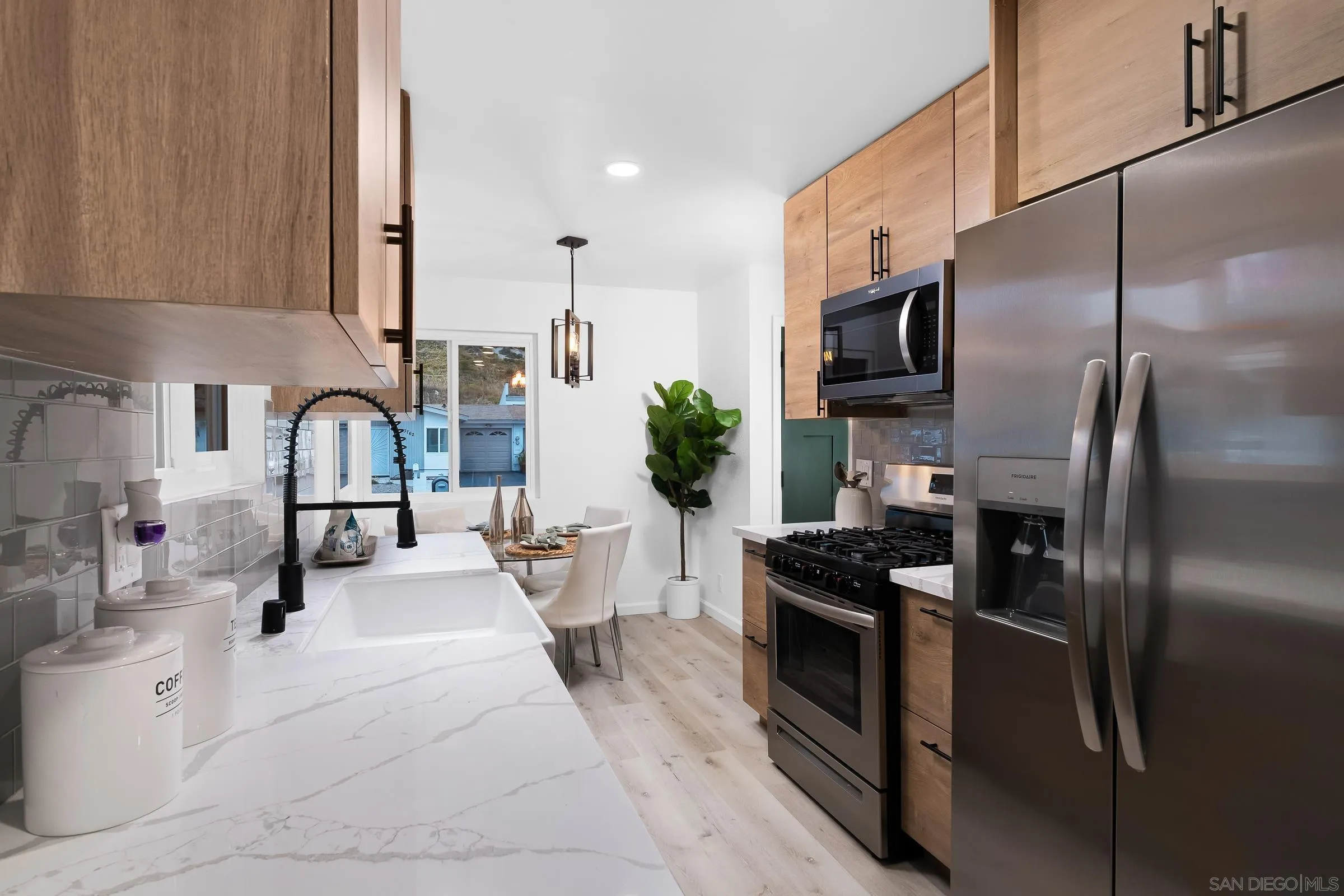 3757 Gail Drive Oceanside, CA 92056 - Photo 10 of 27 a kitchen with stainless steel appliances kitchen island granite countertop a refrigerator a sink a stove and white cabinets