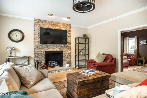 a living room with furniture a flat screen tv and a fireplace