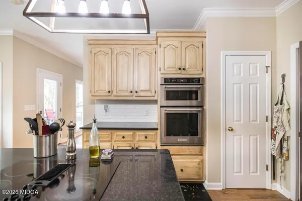 a kitchen with stainless steel appliances a stove and more cabinets