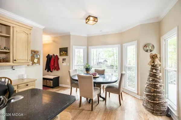 a view of a dining room with furniture window and wooden floor