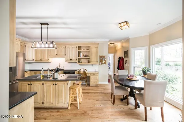 a living room with furniture a dining table and a chandelier