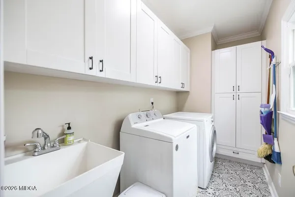 a utility room with a sink a washer and dryer