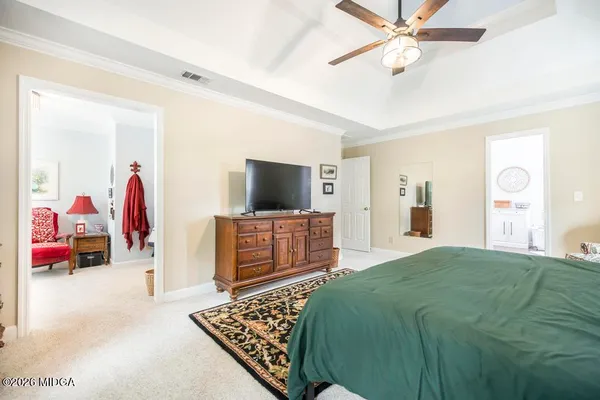 a living room with furniture a ceiling fan and a window