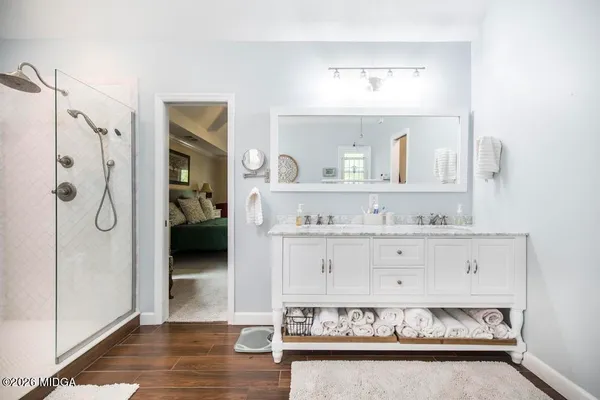 a view of walk in closet with clothes and shoes