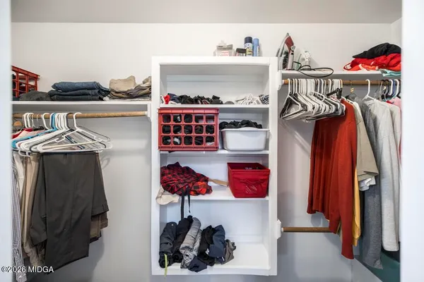 a spacious bedroom with a bed and a couch