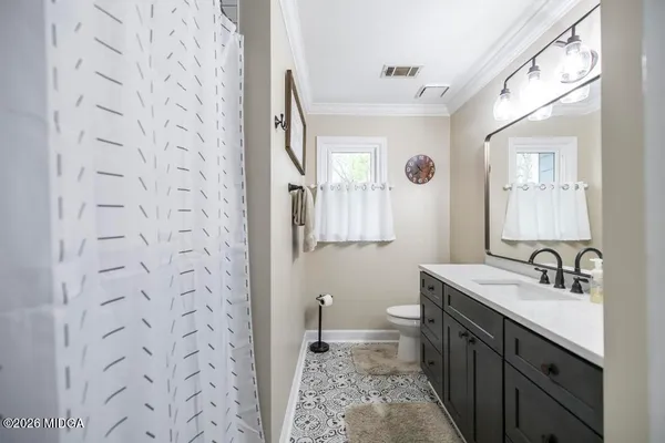 a bedroom with a bed couch and a window