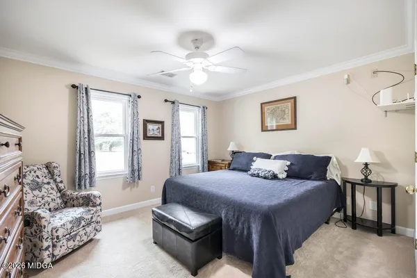 a view of bedroom with a ceiling fan