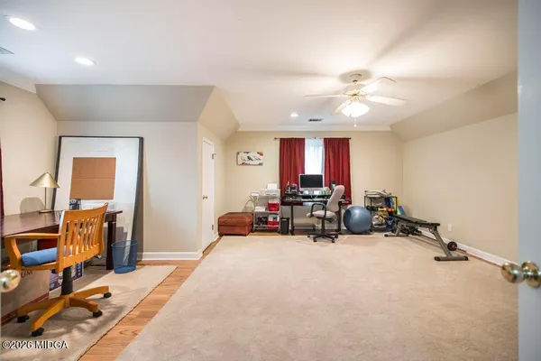 a view of a livingroom with furniture and a ceiling fan