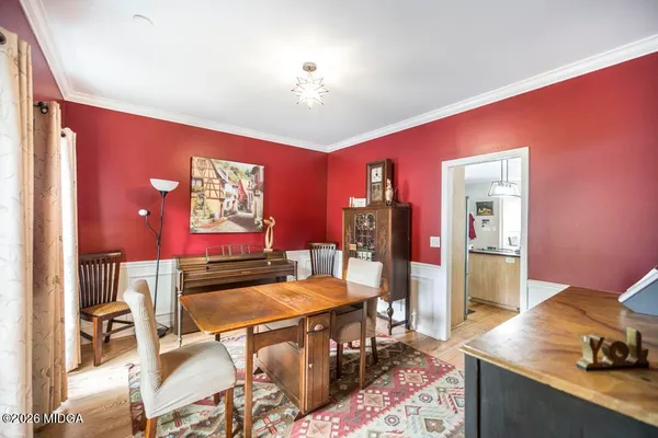 a view of a dining room with furniture and chandelier