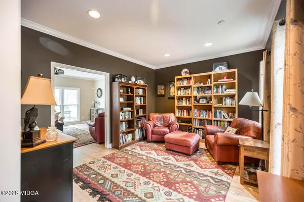 a living room with furniture and a book shelf