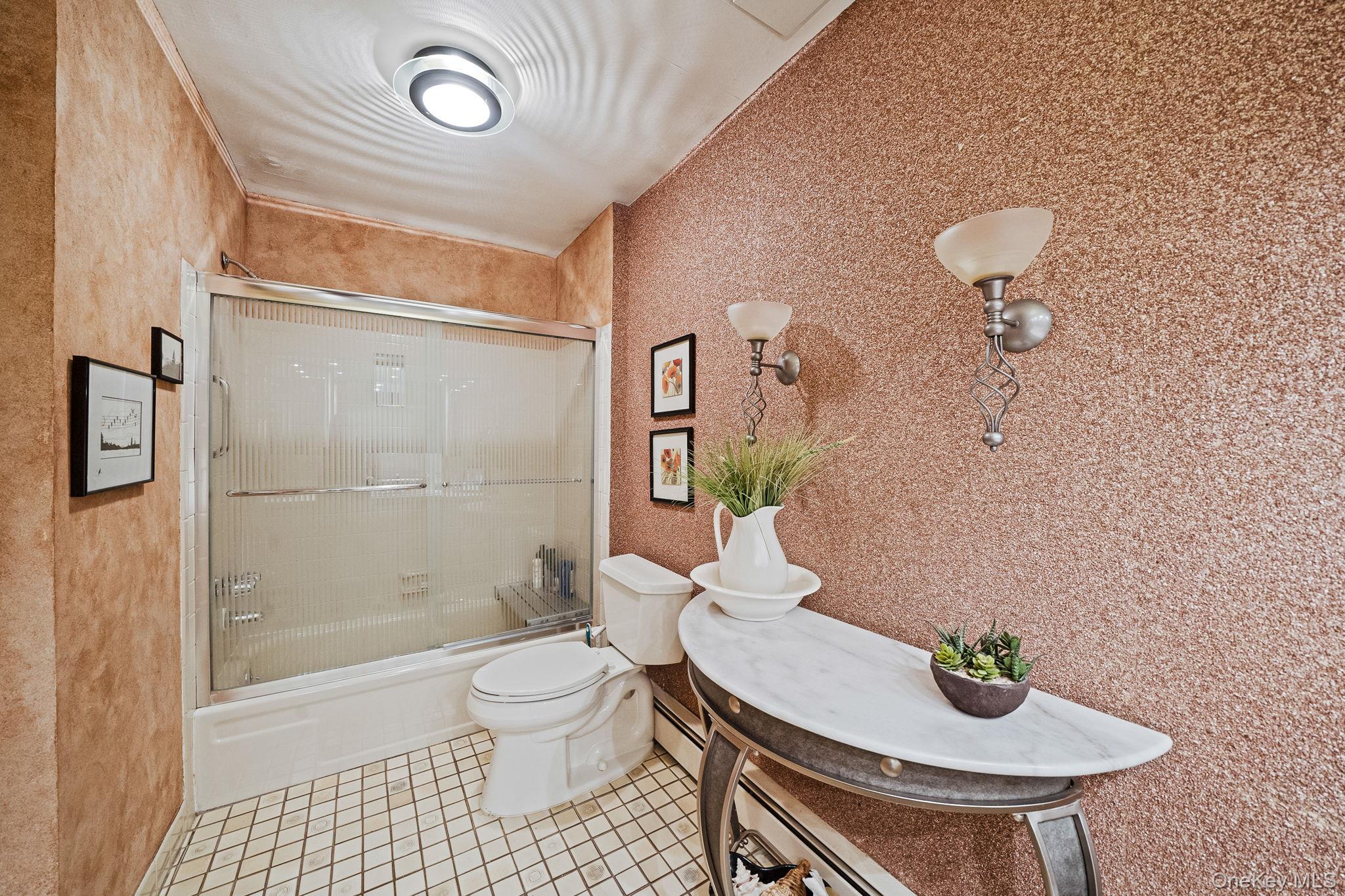 96 Fulton Boulevard Commack, NY 11725 - Photo 35 of 41 a bathroom with a sink a toilet and shower