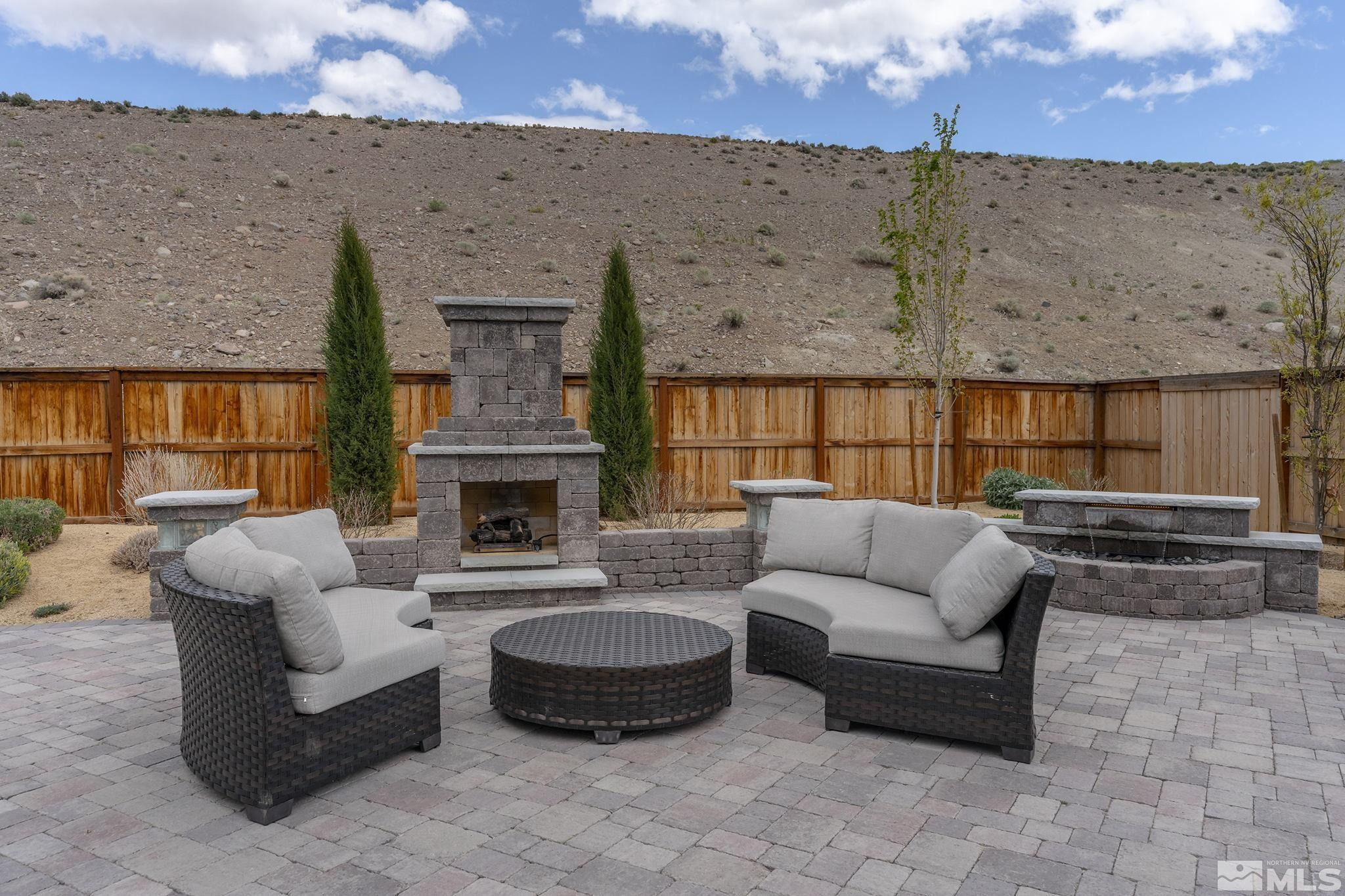 3325 Show Jumper Lane Reno, NV 89521 - Photo 23 of 34 an outdoor living area with furniture and a fireplace