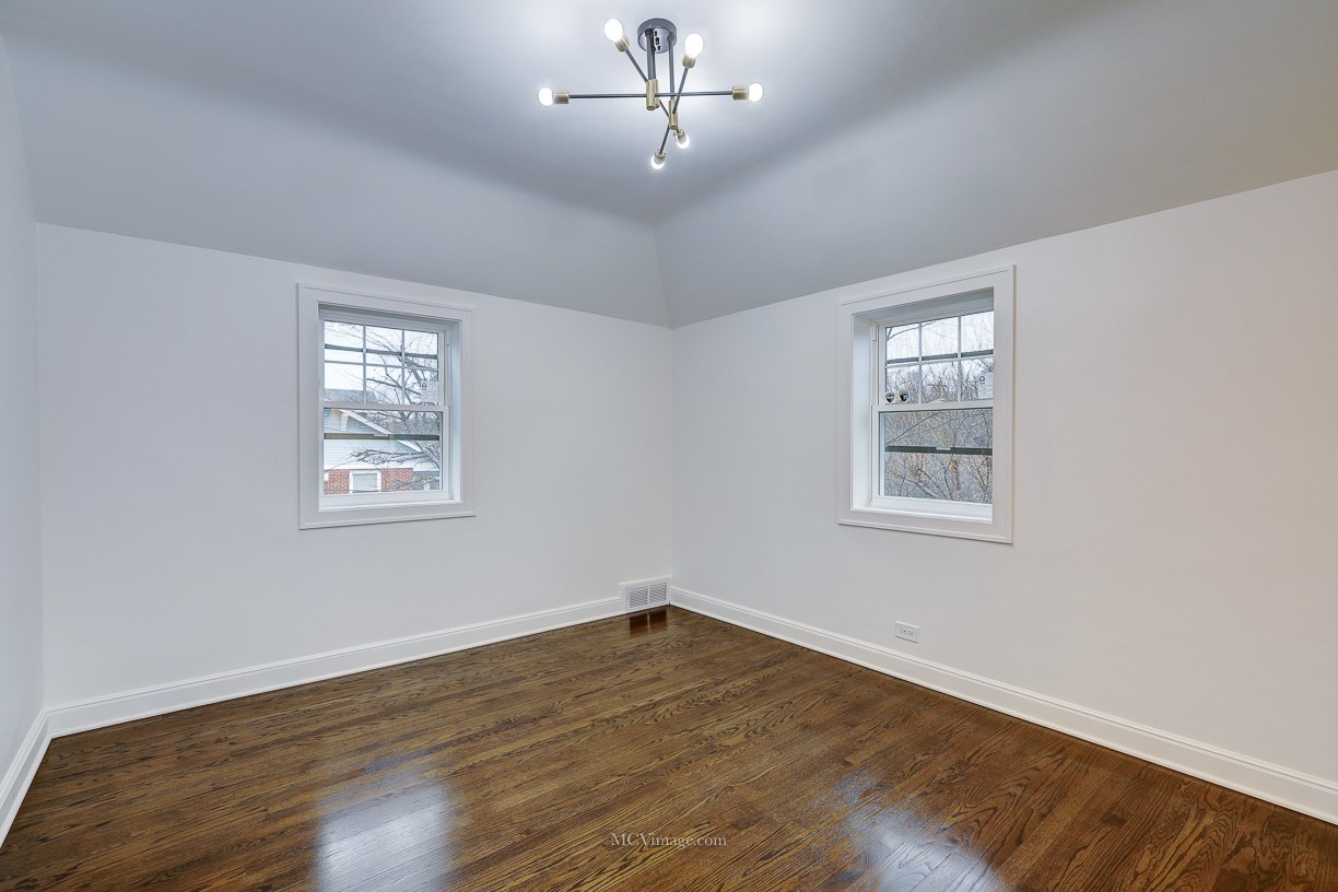336 Nuttall Road Riverside, IL 60546 - Photo 31 of 34 a view of a room with wooden floor chandelier and windows