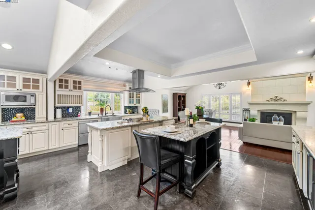 a kitchen with stainless steel appliances granite countertop a stove and a sink