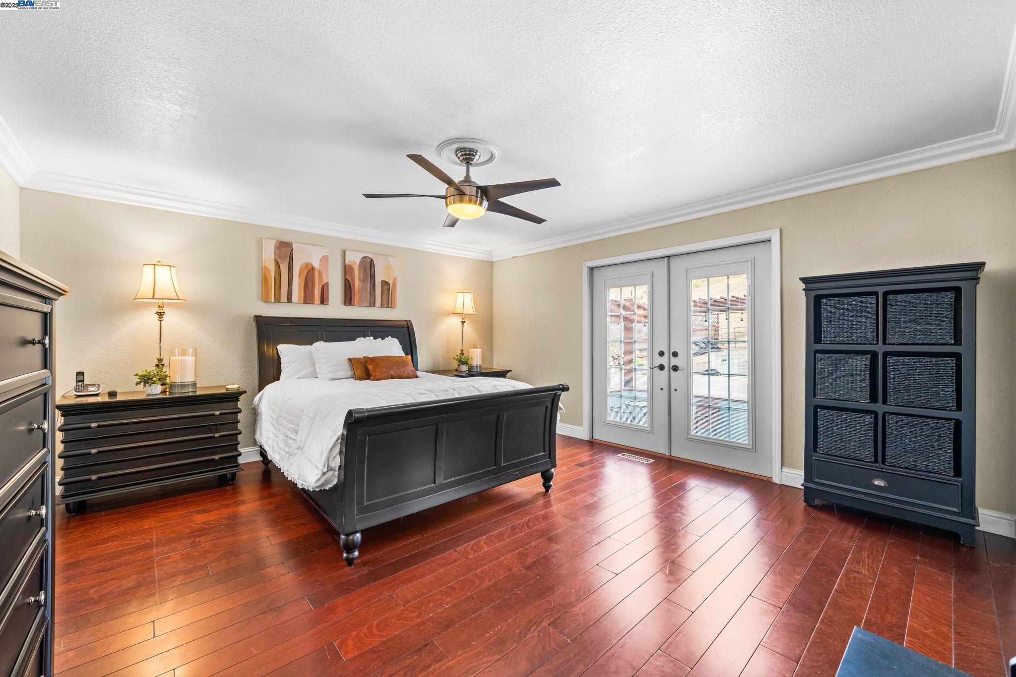 26928 Palomares Road Castro Valley, CA 94552 - Photo 32 of 58 a bedroom with a bed and a ceiling fan