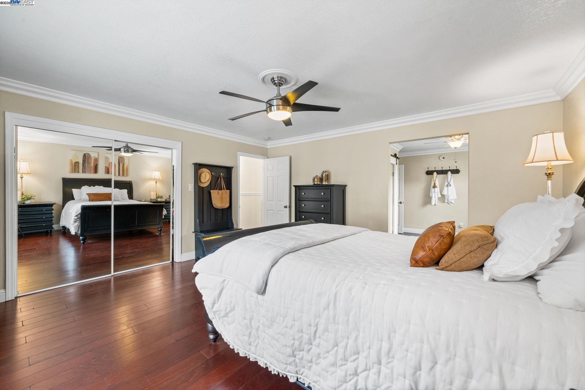26928 Palomares Road Castro Valley, CA 94552 - Photo 33 of 58 a bedroom with a large bed and a chandelier