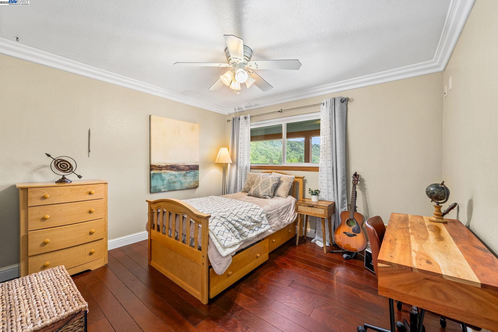 26928 Palomares Road Castro Valley, CA 94552 - Photo 36 of 58 a bedroom with a bed and a table in it