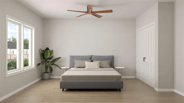 a bedroom with a bed and a potted plant