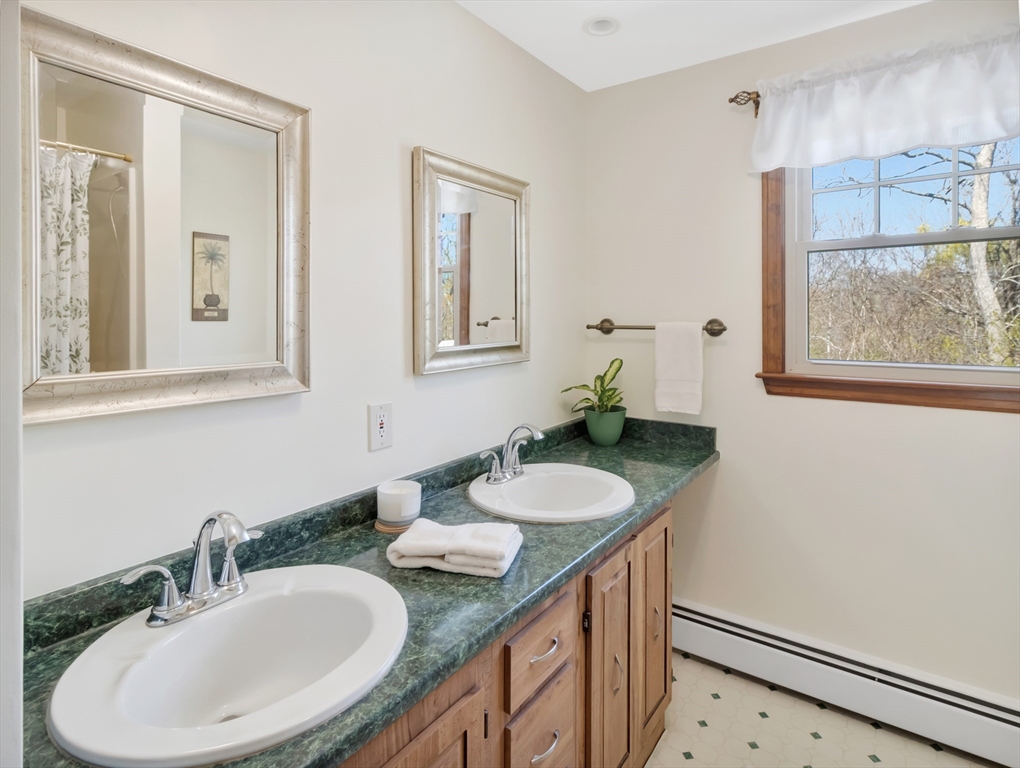 15 Riverside Drive Mansfield, MA 02048 - Photo 17 of 42 a bathroom with a granite countertop sink and a mirror