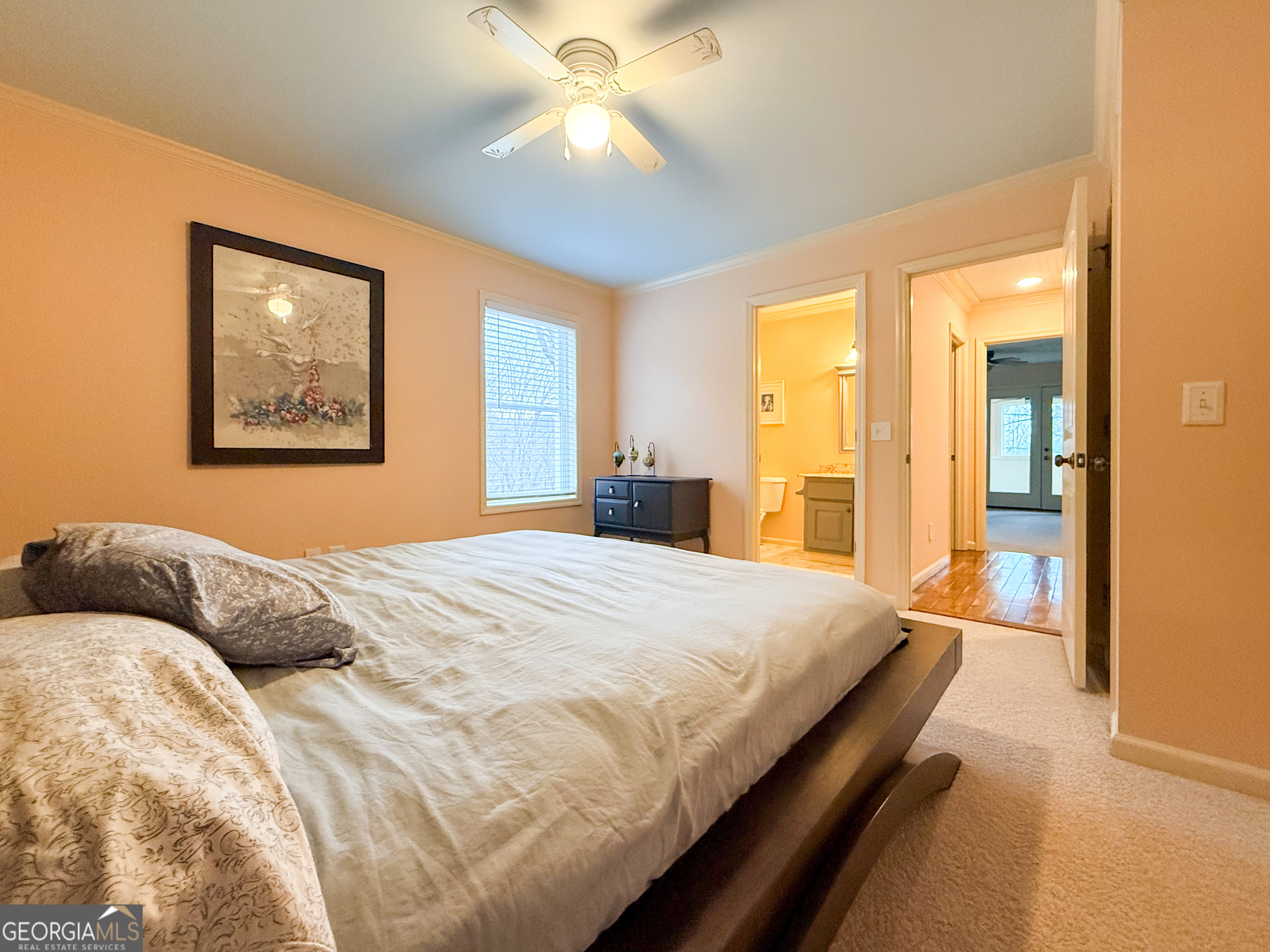 406 Yonah Mountain Road Cleveland, GA 30528 - Photo 17 of 65 a bedroom with a large bed and a chandelier