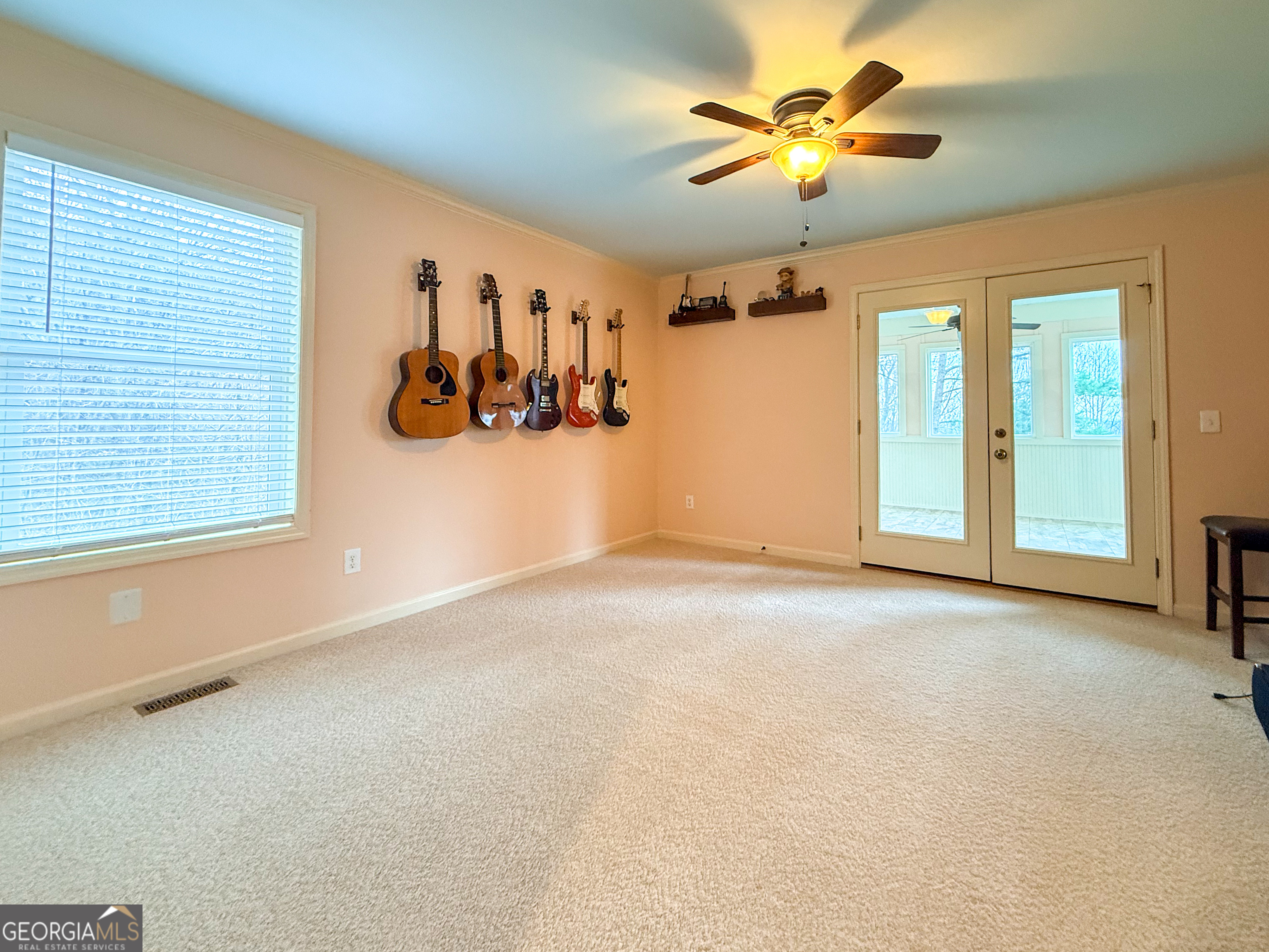 406 Yonah Mountain Road Cleveland, GA 30528 - Photo 19 of 65 an empty room with windows and ceiling fan