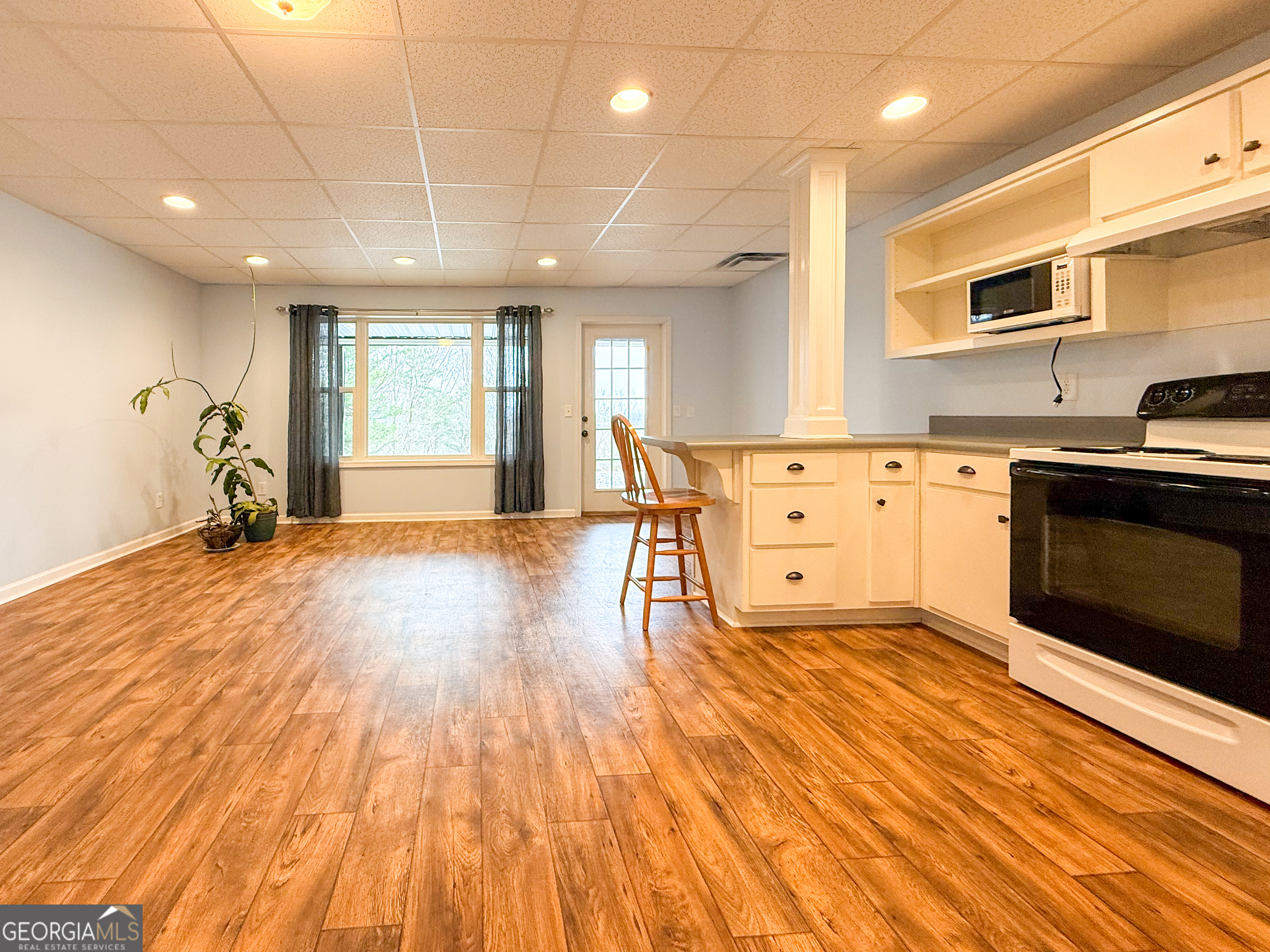 406 Yonah Mountain Road Cleveland, GA 30528 - Photo 39 of 65 a large kitchen with stainless steel appliances granite countertop a stove and a wooden floors