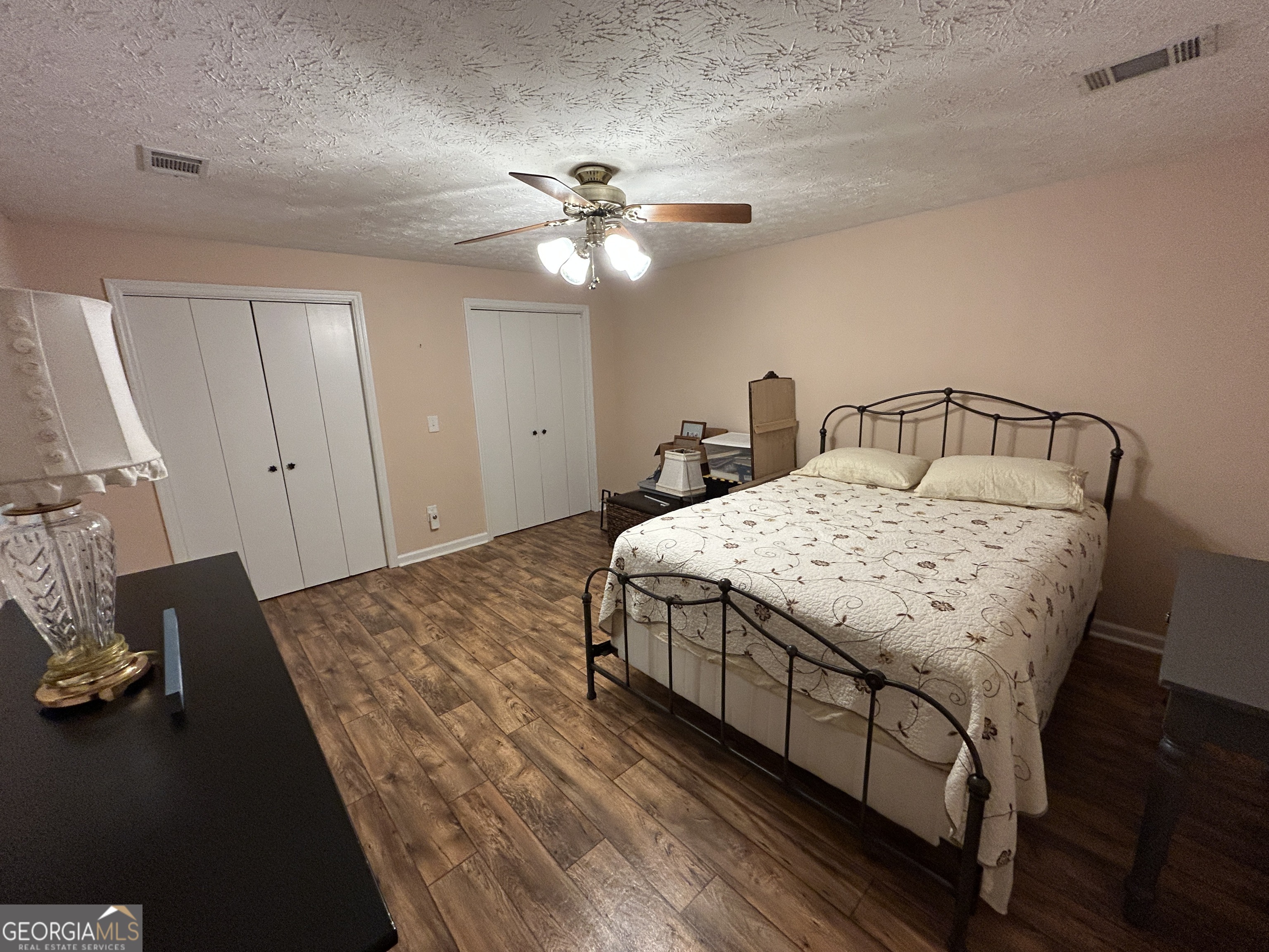 406 Yonah Mountain Road Cleveland, GA 30528 - Photo 44 of 65 a bedroom with a bed and a chandelier