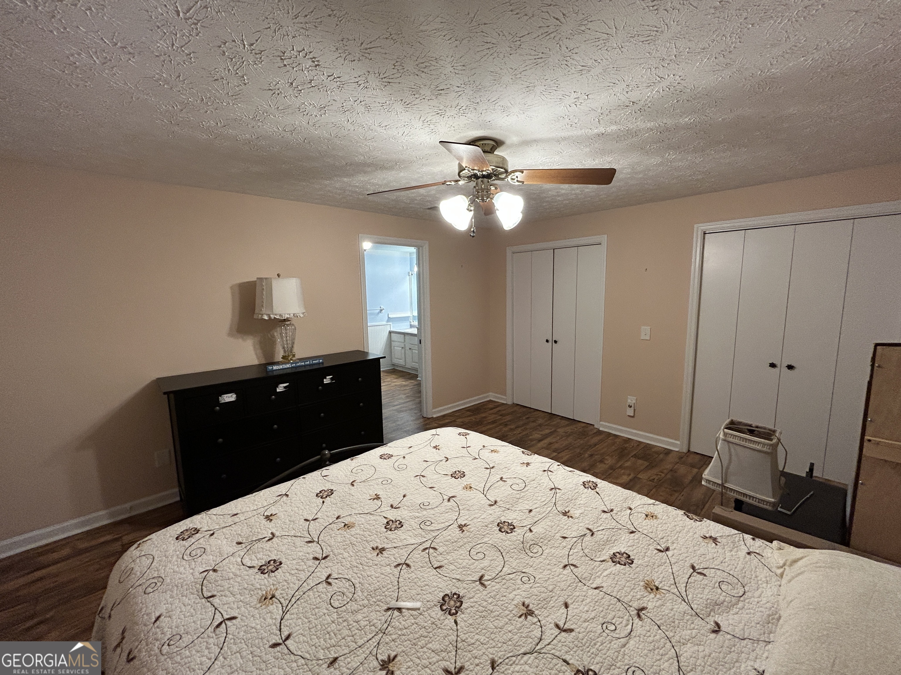 406 Yonah Mountain Road Cleveland, GA 30528 - Photo 45 of 65 a bedroom with a bed and a chandelier