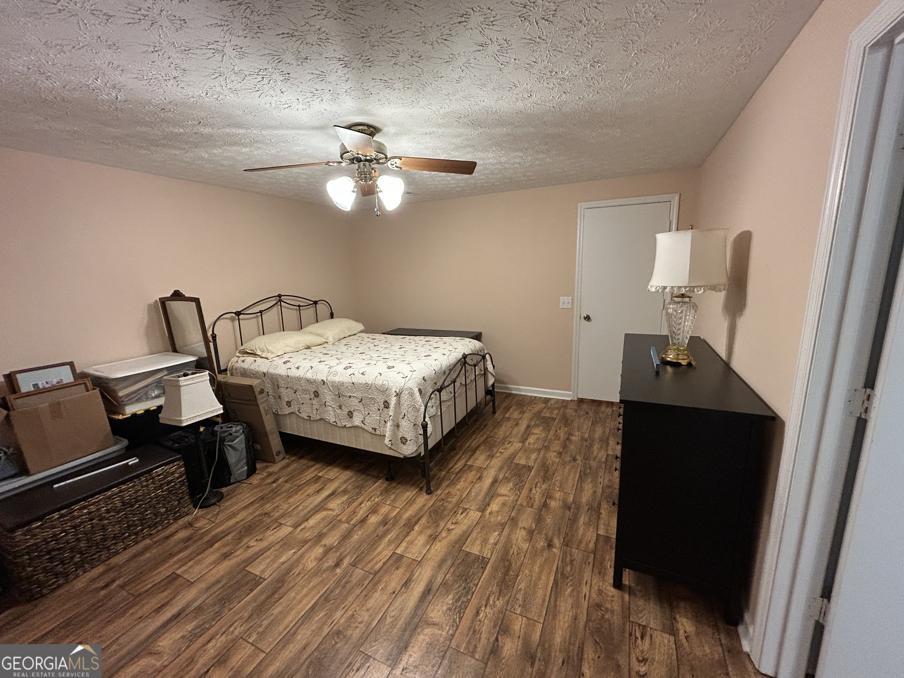 406 Yonah Mountain Road Cleveland, GA 30528 - Photo 46 of 65 a bedroom with a bed and wooden floor